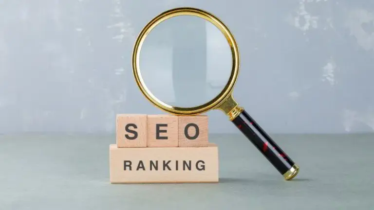A magnifying glass rests atop wooden blocks spelling out "SEO Ranking," illustrating the concept of search engine optimization ranking.