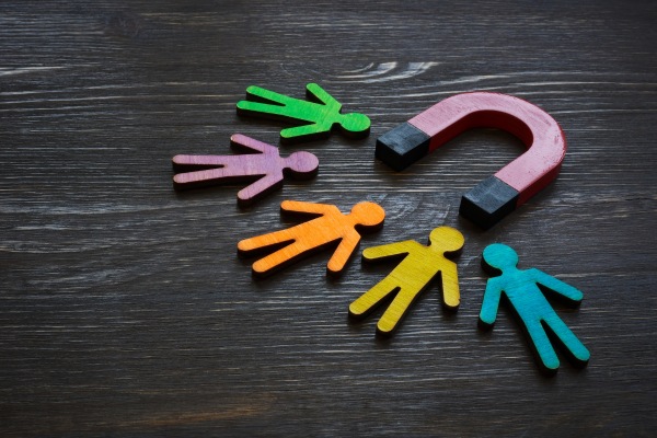 Magnet attracting colorful human-shaped figures representing customers