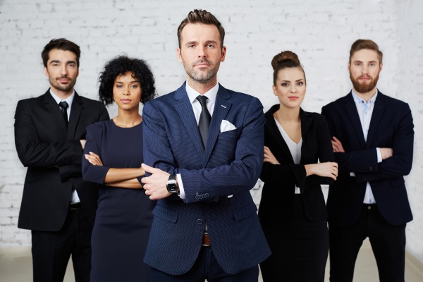 Confident group of lawyers in formal attire.